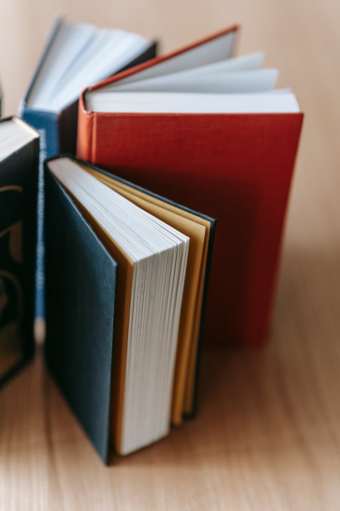 Crafting Captivating Headlines: Your awesome post title goes here From above collection of new book with black and red hardcovers arranged in wooden table in light library